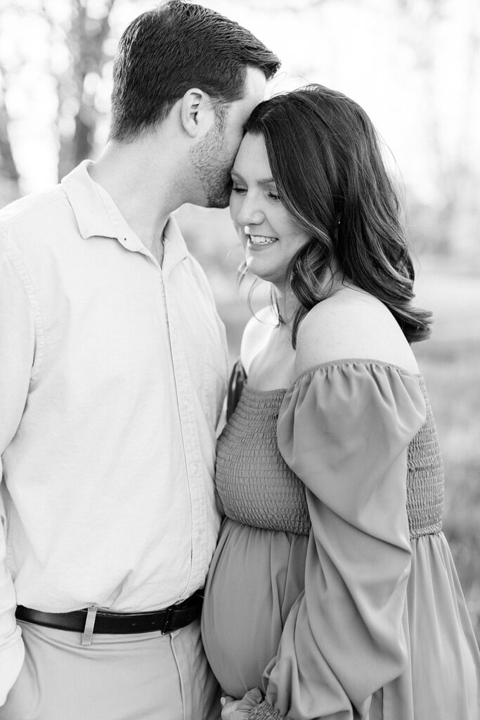 A black and white maternity photo of an expectant coouple in an Indianapolis field.