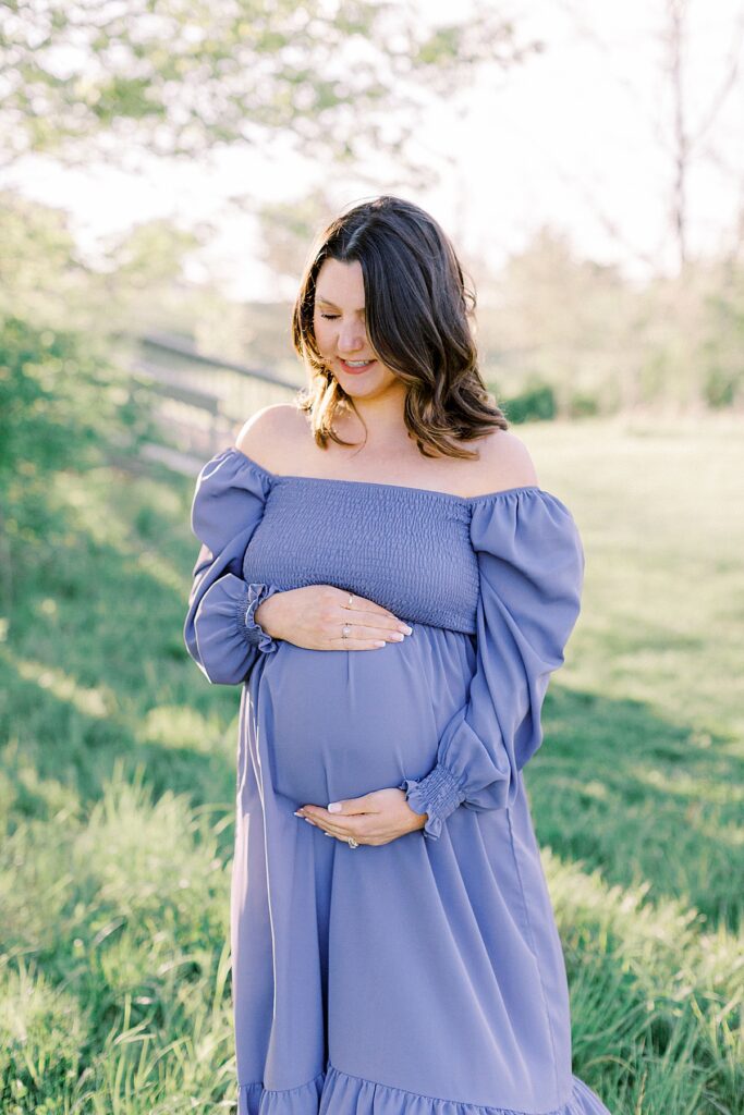 A pregnant mother holds her growing belly in a maternity photo by Indianapolis Photographer Katelyn Ng