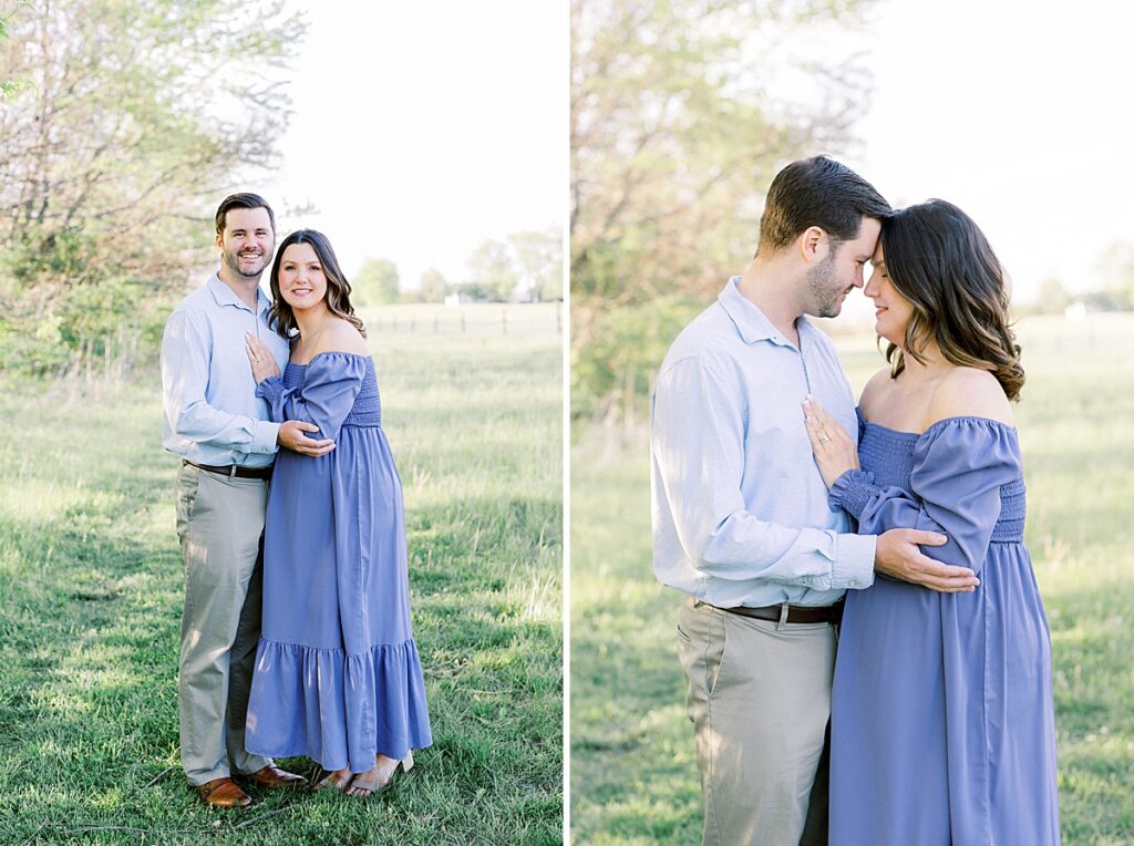 A couple stands in a field, posing for a maternity photo