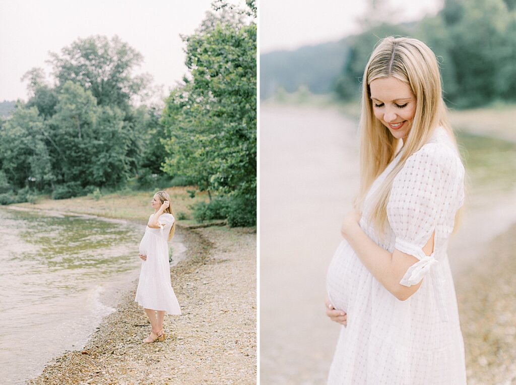 A woman in a white dress poses for maternity portraits on the edge of Lake Monroe in Bloomington Indiana.