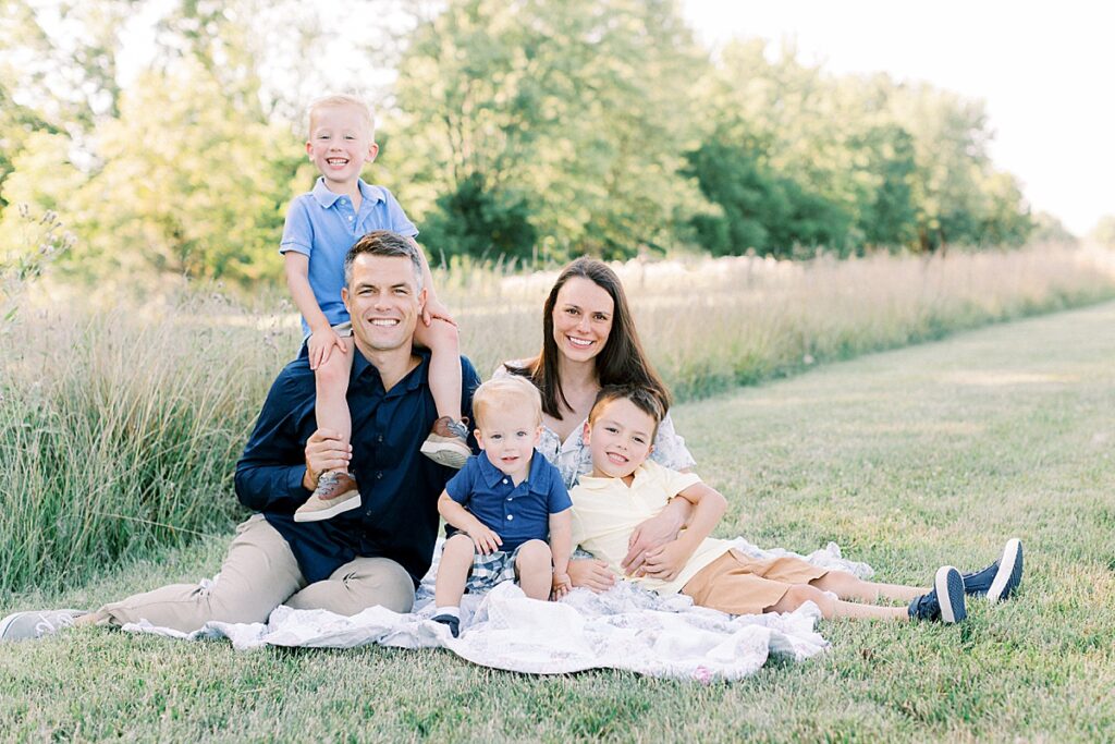 Family of five smiles at the camera in a photo by Katelyn Ng Photography