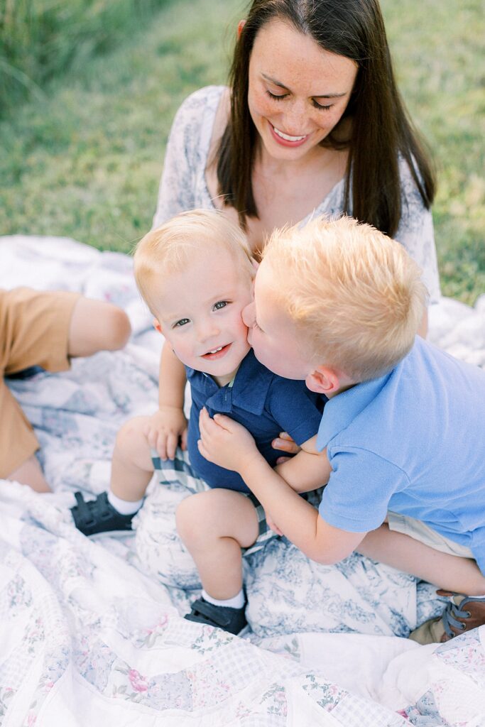 a mother poses with two of her sons in a photo by Greenwood family photographer Katelyn Ng