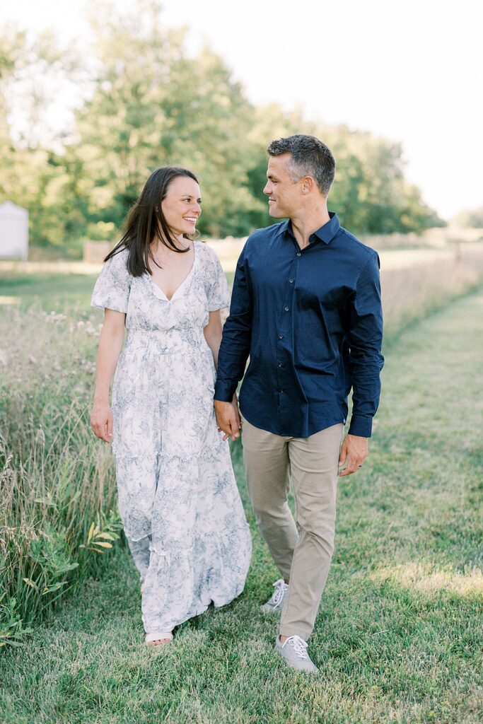 A mom and dad walk together in a family photo by Greenwood Indiana photographer Katelyn Ng Photography