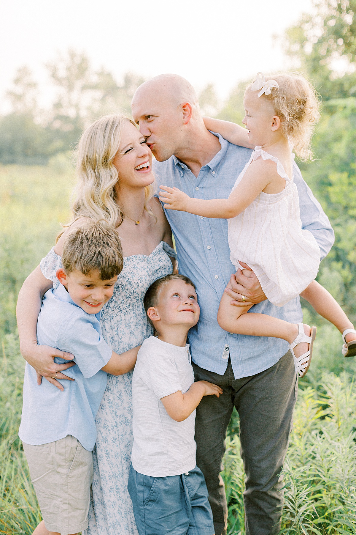 Carmel, Indiana family poses in a field for a photo by Katelyn Ng Photography.