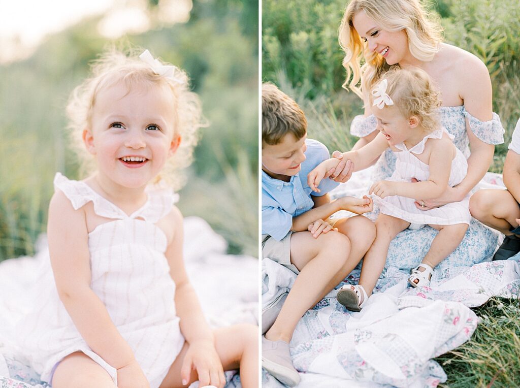 a little girl sits a blanket and smiles while her mother and brother play with her in a photo by Carmel Indiana family photographer Katelyn Ng Photography.