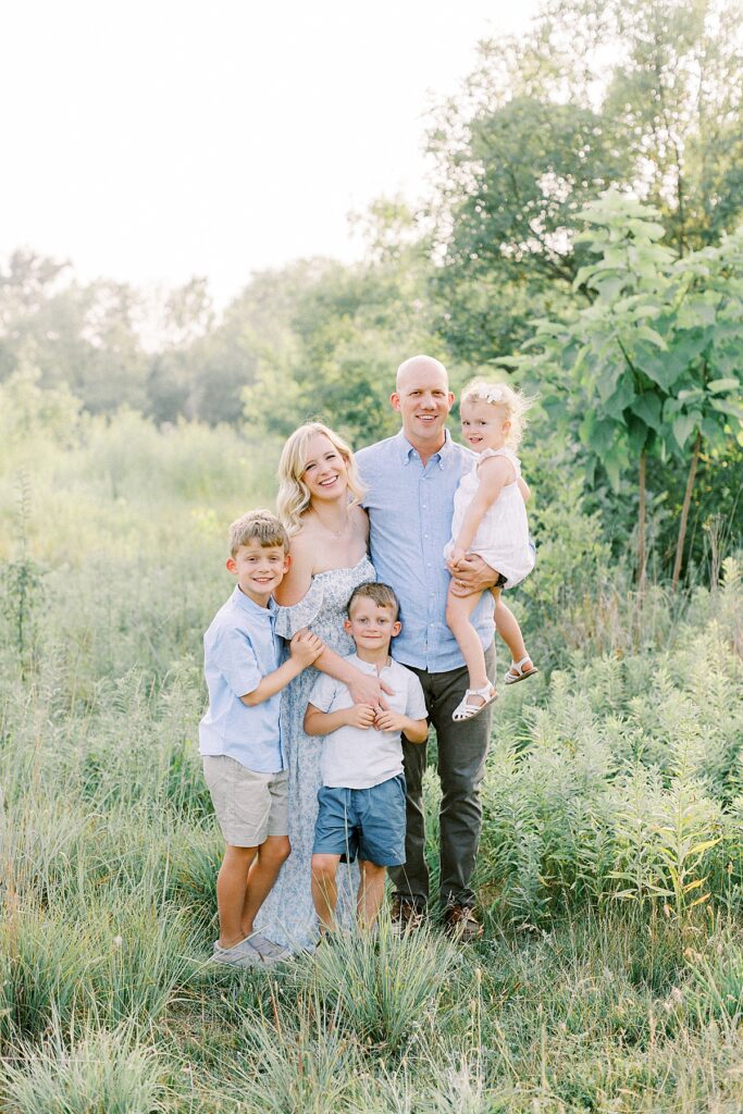 Family poses at Central Park in Carmel Indiana in a photo by family photographer Katelyn Ng Photography.