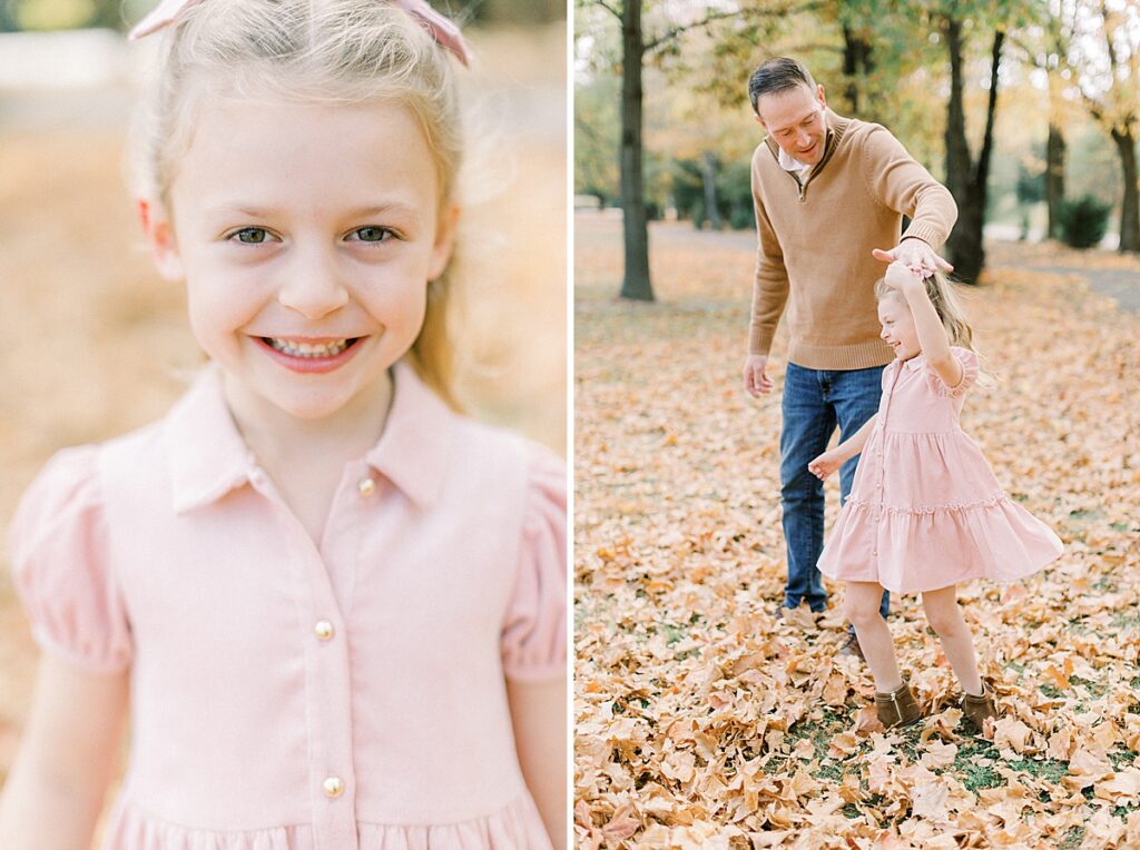 A dad dances with his young daughter who is dressed in pink. She twirls and smiles at the camera during their Carmel, Indiana fall family photos.