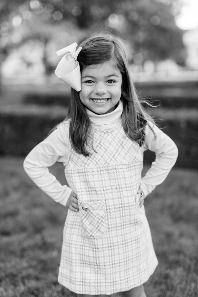 A black and white portrait of a little girl with a bow in her hair by Carmel, Indiana family photographer Katelyn Ng Photography.
