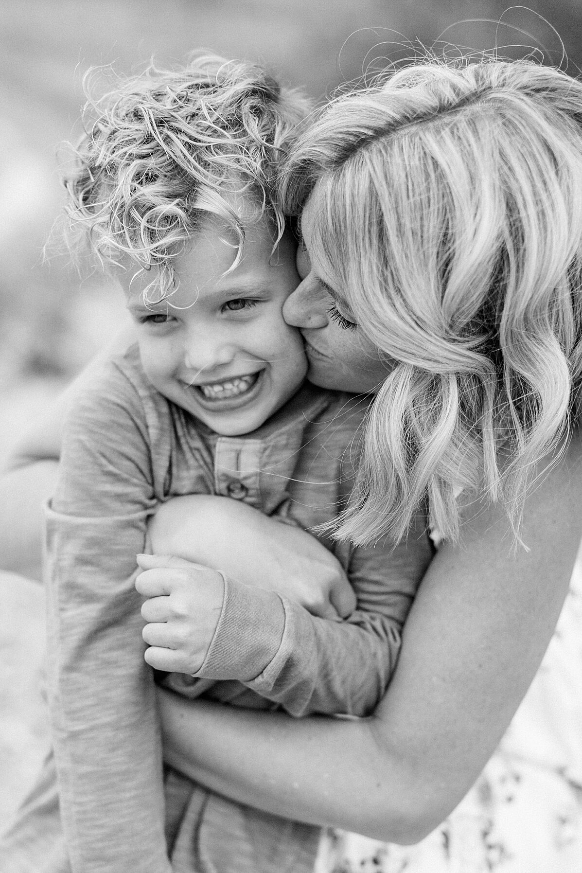 A black and white portrait of a mother with her curly haired son by Bloomington, Indiana family photographer Katelyn Ng Photography.