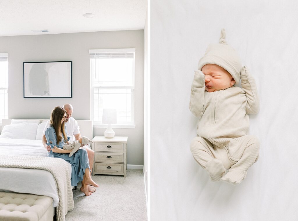 A father and mother sit on the edge of their bed, holding their newborn baby boy in a photo by Indianapolis in-home newborn photographer Katelyn Ng. 