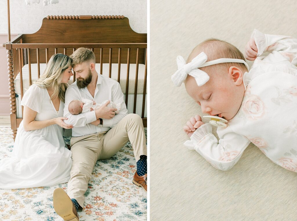 A little girl sleeps with her pacifier in her mouth as her parents touch their foreheads together and enjoy a quiet moment in the nursery.